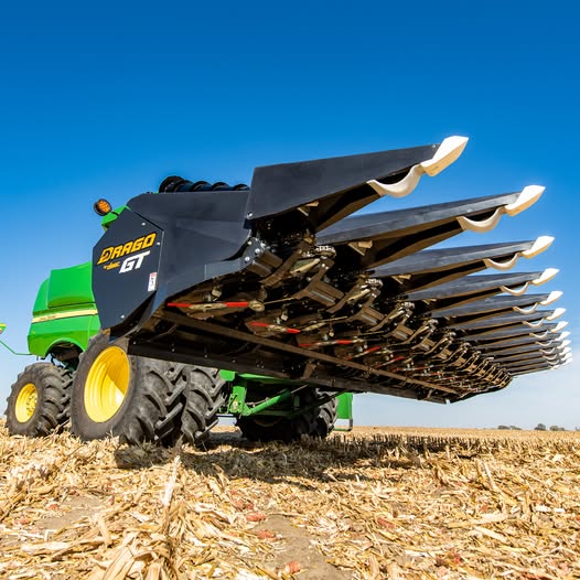 Drago GT corn head mounted on a John Deere combine in a harvested cornfield