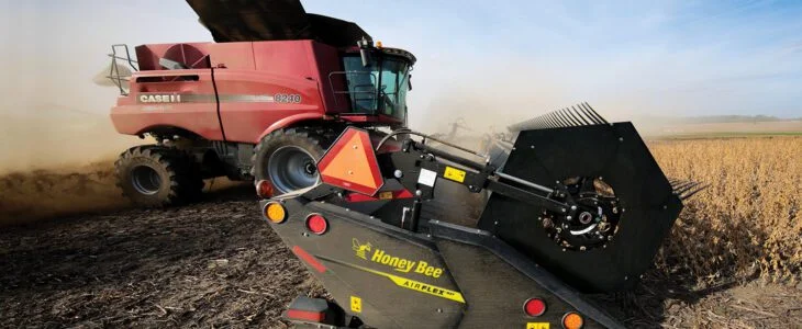 Honey Bee draper header on a Case IH combine in a soybean field