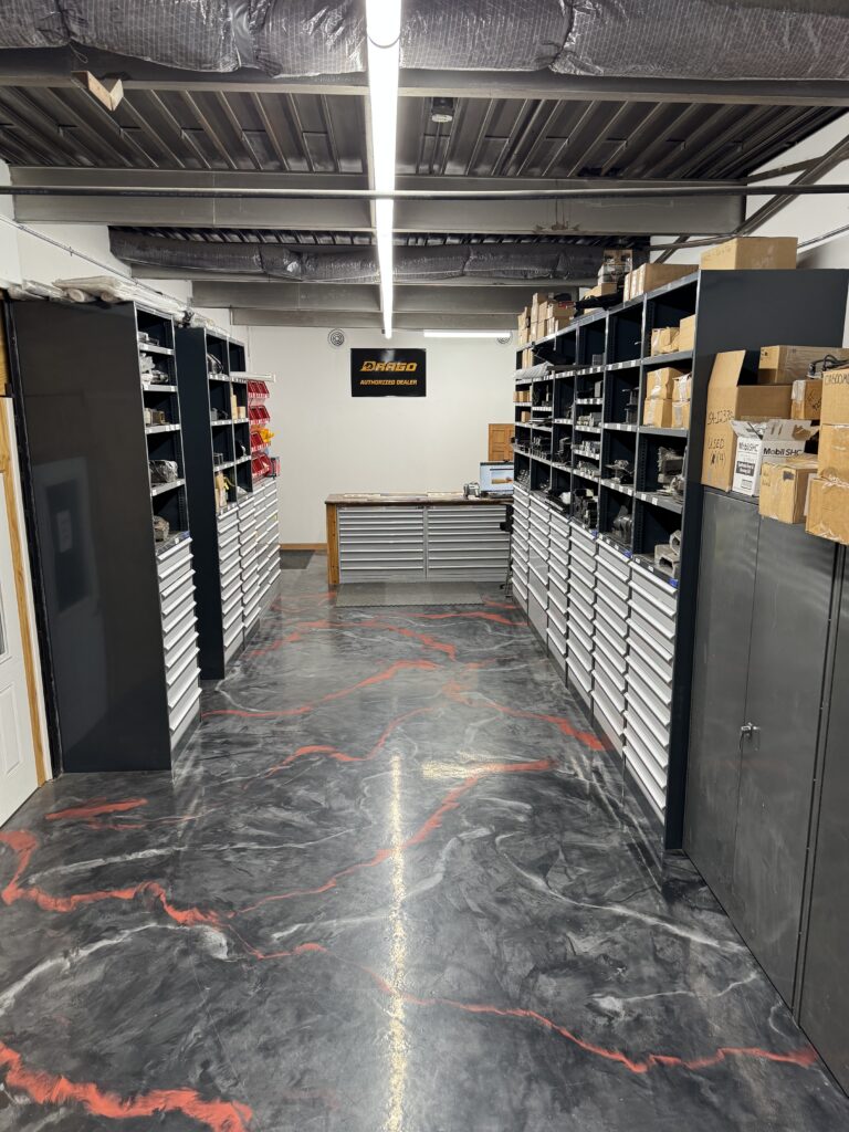Drago S.C.I. parts room aisle with the Drago authorized dealer sign